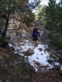 Mike hiking down the snow at the top of Tanner Trail